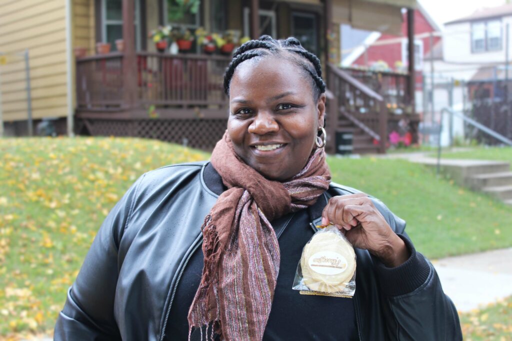 A resident holding a cookie during the rock the block event.