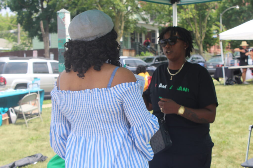 Amani resident talking to an Amani United volunteer.