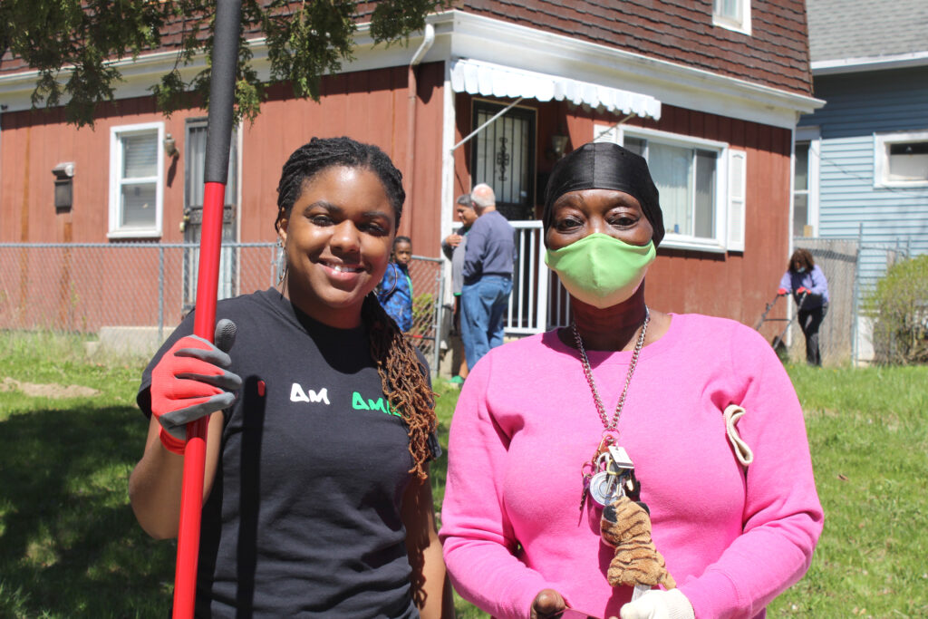 Two residents in front of a lawn during the rock the block event.